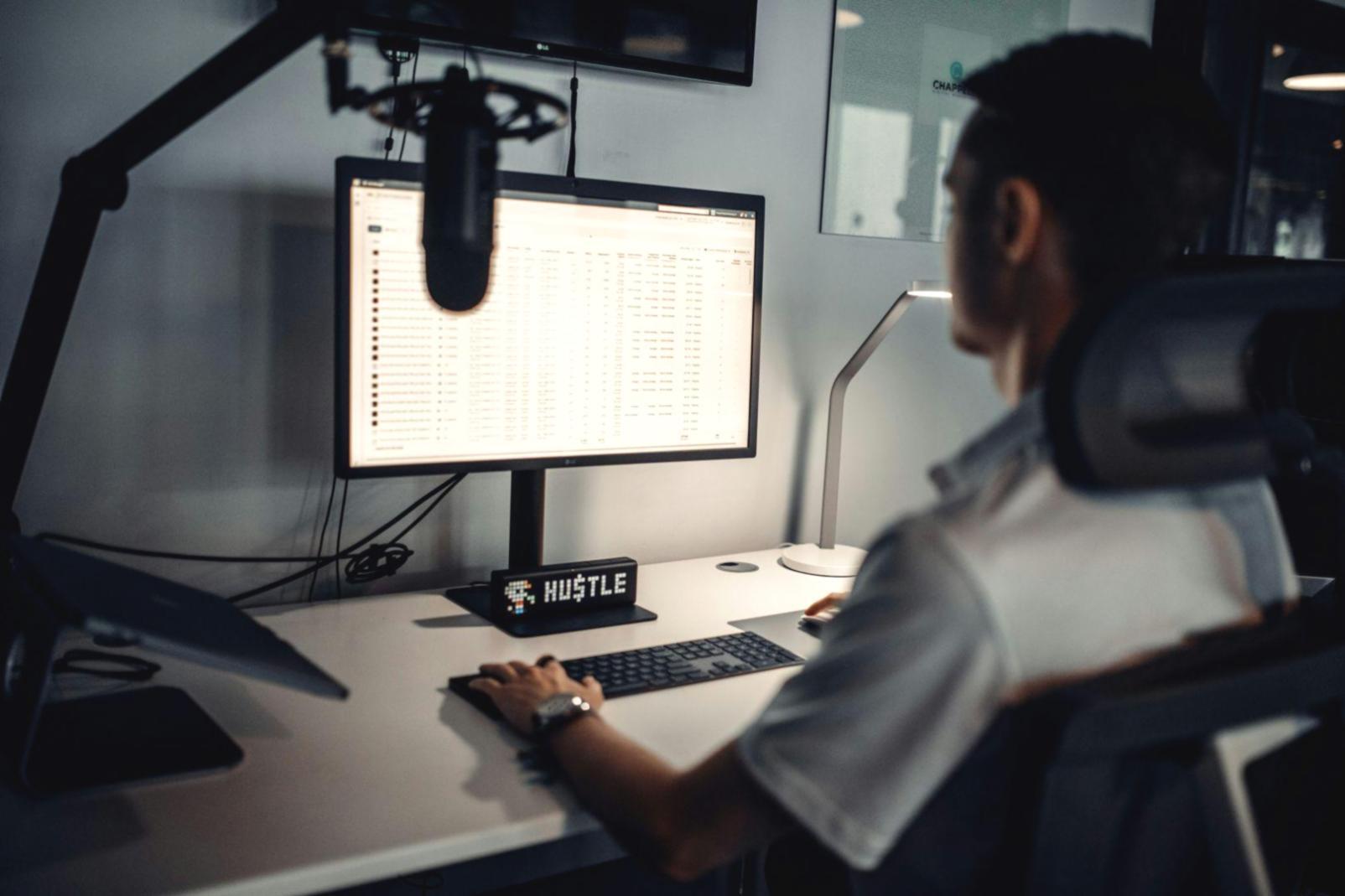 Business analysis professional reviewing financial data on multiple screens